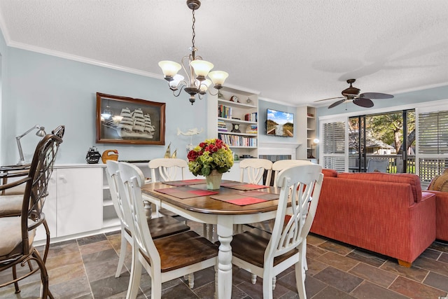 dining room with ceiling fan with notable chandelier, built in shelves, a textured ceiling, and ornamental molding