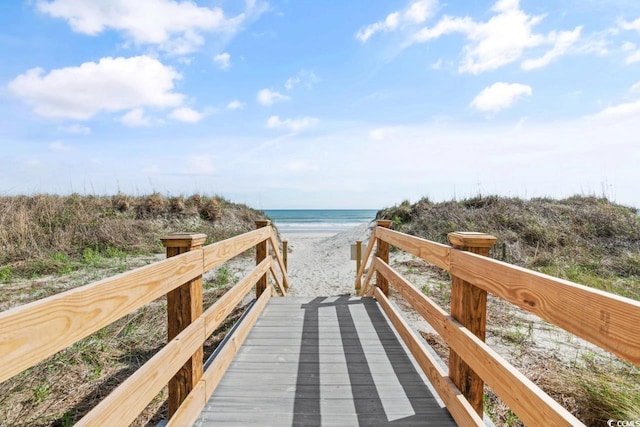 view of community featuring a water view and a view of the beach