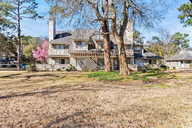 back of property featuring a lawn