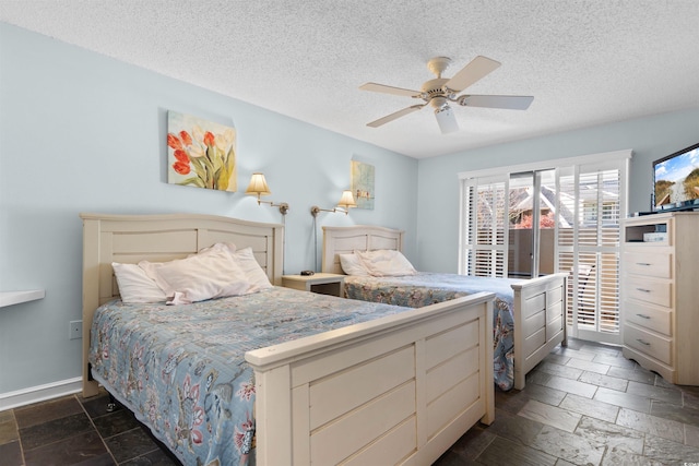 bedroom with a textured ceiling and ceiling fan