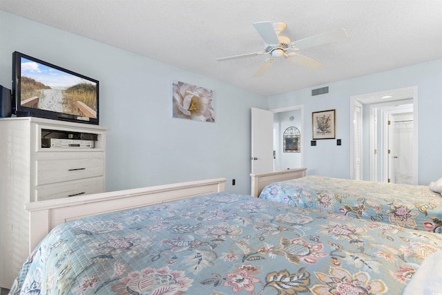 bedroom featuring ceiling fan and a textured ceiling