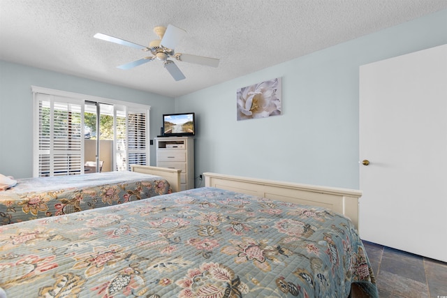 bedroom featuring ceiling fan and a textured ceiling