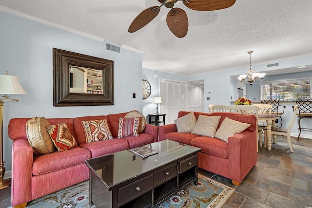 living room featuring ceiling fan with notable chandelier, ornamental molding, and a textured ceiling