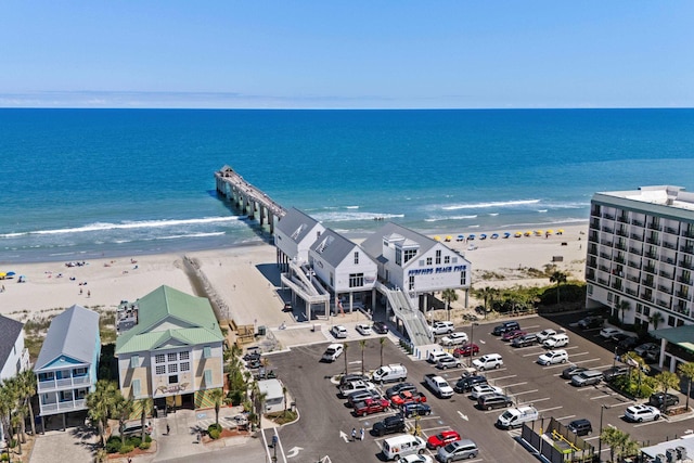 drone / aerial view featuring a water view and a beach view