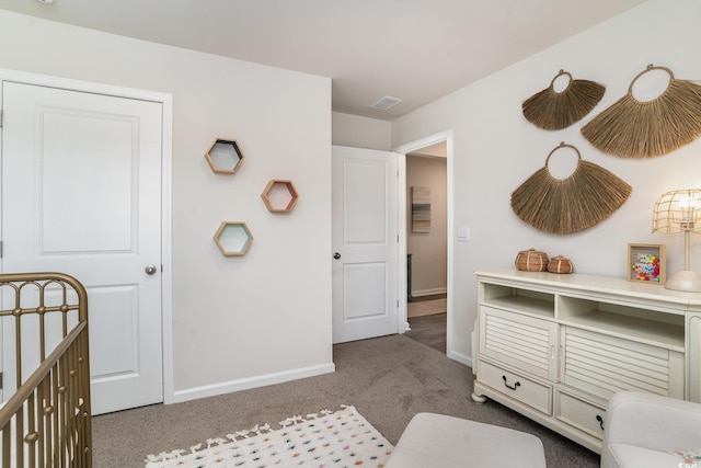 carpeted bedroom with a nursery area