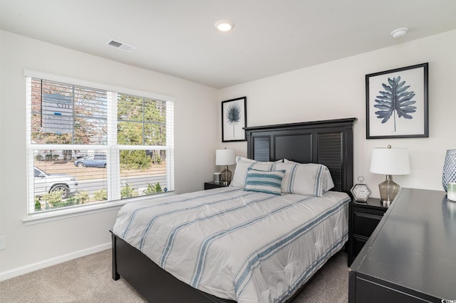 bedroom with carpet flooring and multiple windows