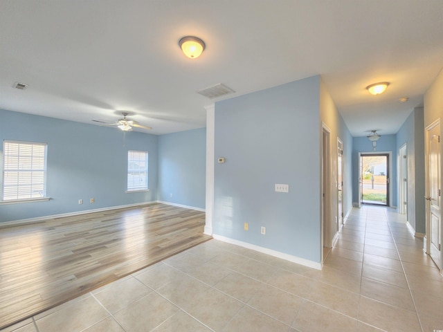 empty room with light hardwood / wood-style floors and ceiling fan