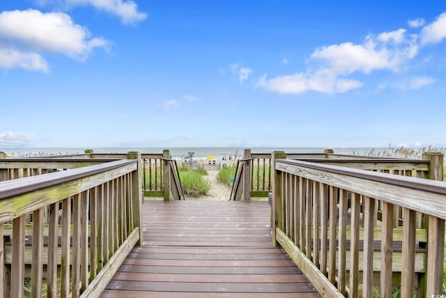 view of property's community with a deck with water view