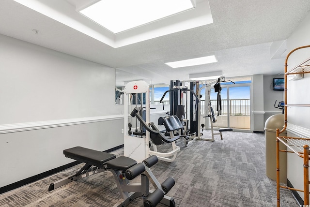 exercise room featuring carpet and a textured ceiling