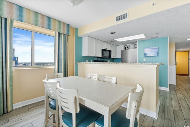 dining area with a textured ceiling