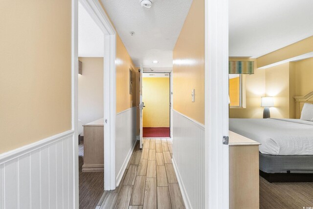 corridor featuring a textured ceiling