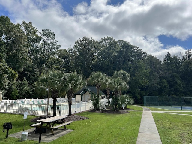 view of property's community with a lawn and a pool