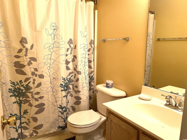 bathroom with tile patterned flooring, vanity, and toilet