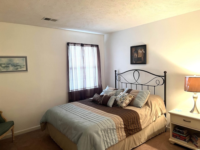 carpeted bedroom featuring a textured ceiling