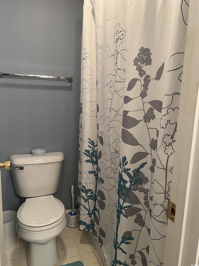 bathroom featuring a shower with curtain, tile patterned flooring, and toilet