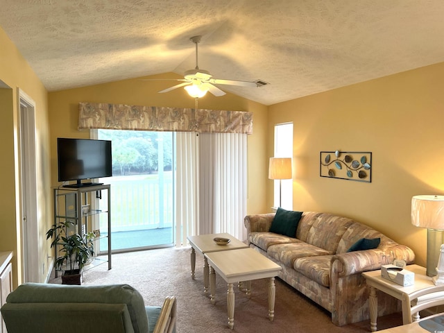 living room with carpet, a textured ceiling, vaulted ceiling, and ceiling fan