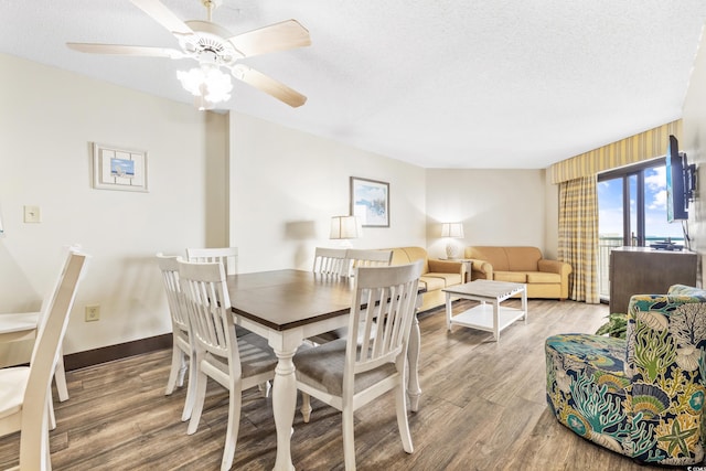 dining area featuring a textured ceiling, ceiling fan, and hardwood / wood-style flooring