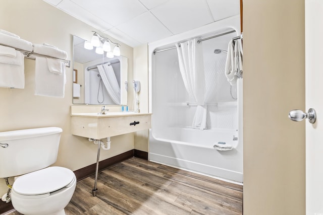 bathroom featuring shower / bathtub combination with curtain, wood-type flooring, and toilet