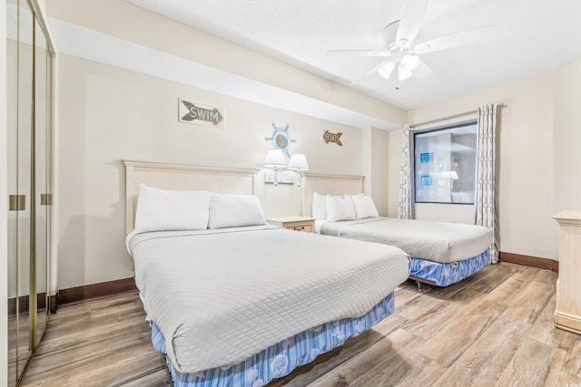 bedroom featuring ceiling fan, hardwood / wood-style floors, and a textured ceiling