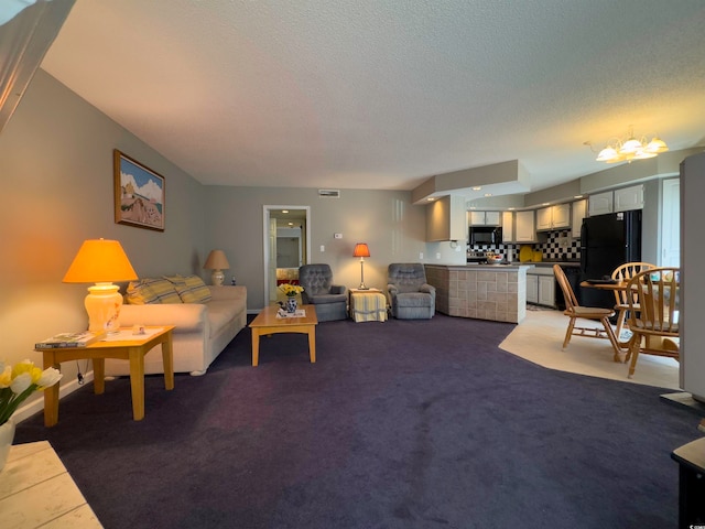 living room featuring carpet, a chandelier, and a textured ceiling