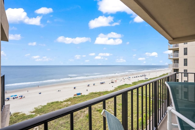 balcony featuring a water view and a beach view