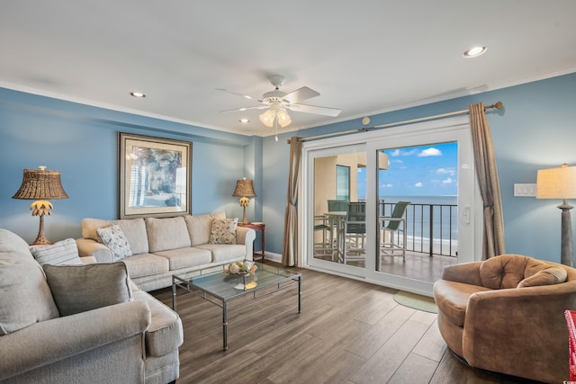 living room with a water view, ceiling fan, and hardwood / wood-style flooring