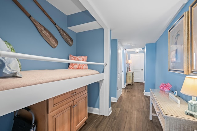 bedroom with dark hardwood / wood-style floors