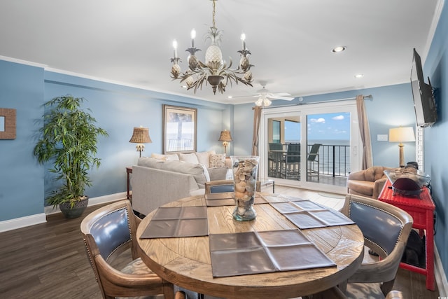 dining space with ceiling fan with notable chandelier, crown molding, and dark hardwood / wood-style flooring