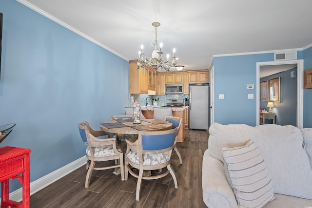 dining room featuring crown molding, sink, dark wood-type flooring, and a notable chandelier