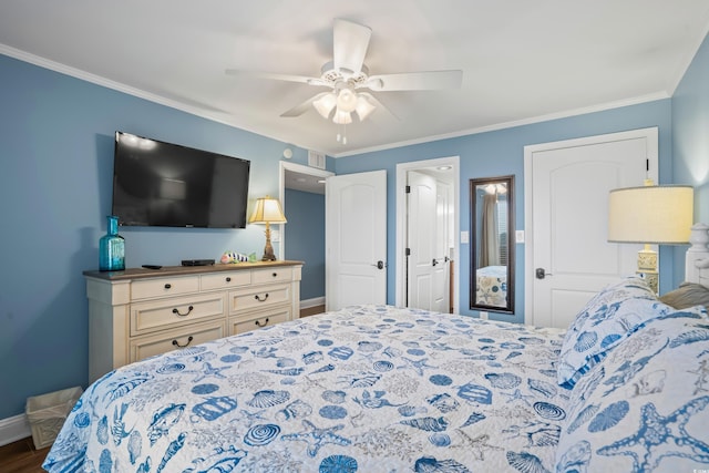 bedroom featuring dark hardwood / wood-style flooring, ceiling fan, and crown molding