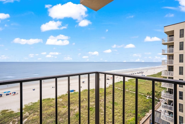 balcony featuring a water view and a beach view