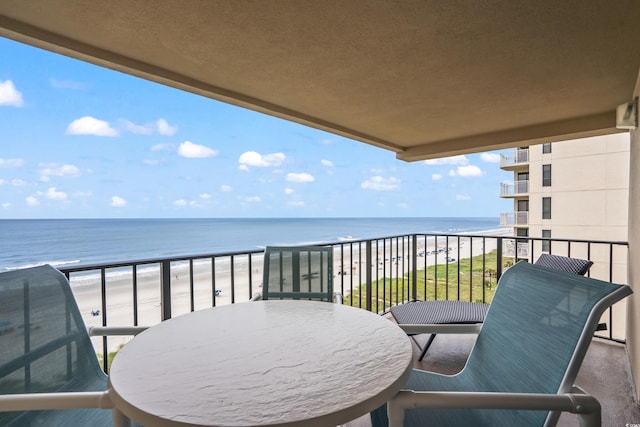 balcony with a view of the beach and a water view