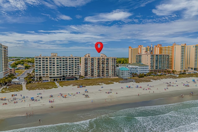 bird's eye view with a water view and a beach view