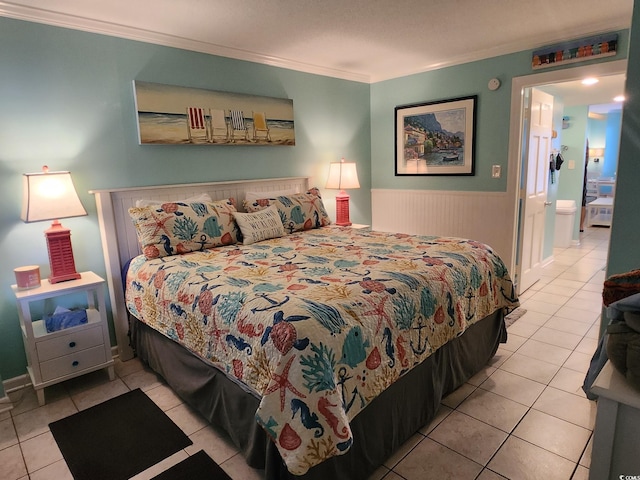 tiled bedroom featuring connected bathroom and crown molding