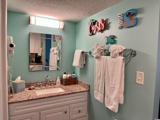 bathroom with vanity and a textured ceiling