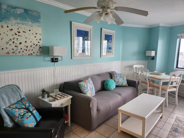 tiled living room featuring ornamental molding, ceiling fan, and a textured ceiling