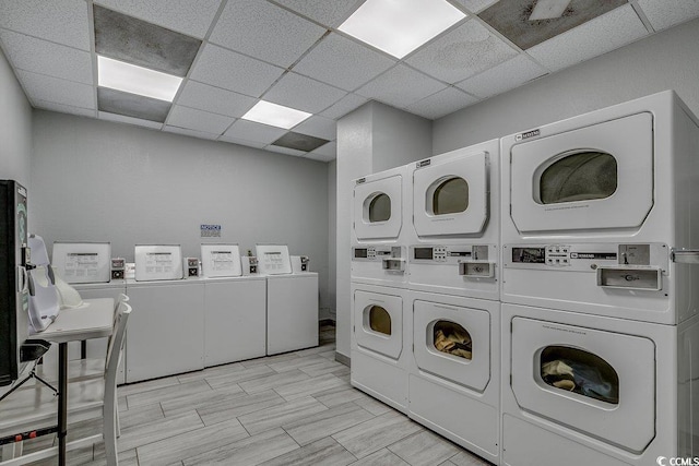 laundry area with washer and clothes dryer and stacked washing maching and dryer