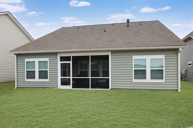 back of house with a sunroom and a yard