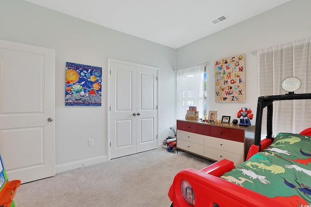 carpeted bedroom with a closet