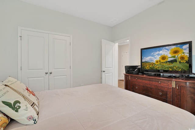 bedroom with wood-type flooring and a closet