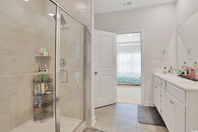 bathroom featuring vanity, tile patterned floors, and an enclosed shower