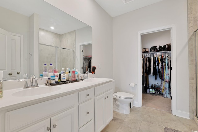 bathroom featuring vanity, tile patterned floors, an enclosed shower, and toilet