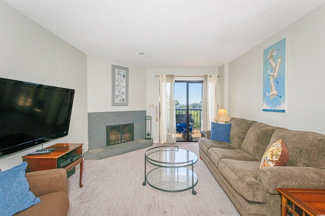 living room featuring carpet floors and a textured ceiling