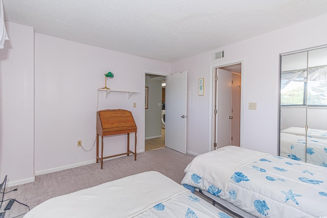 carpeted bedroom featuring a textured ceiling