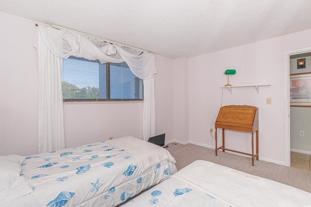 carpeted bedroom featuring a textured ceiling