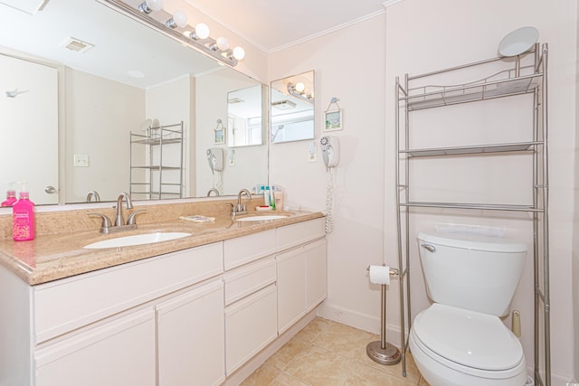 bathroom with tile patterned flooring, crown molding, vanity, and toilet