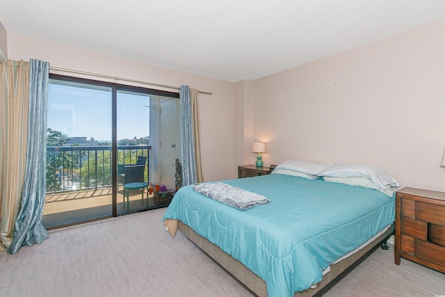 bedroom with access to outside, carpet floors, and a textured ceiling