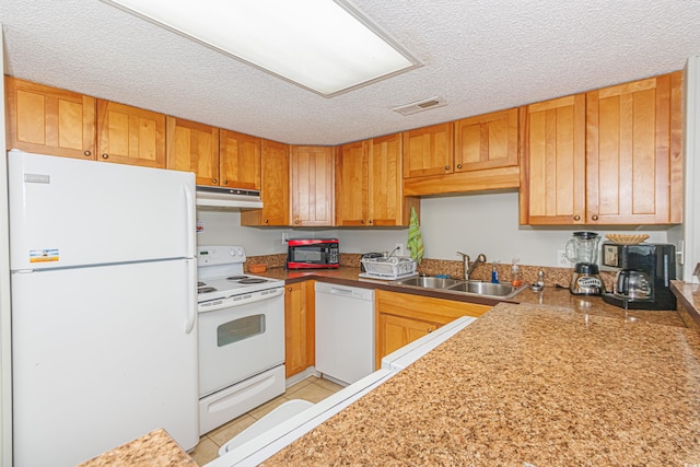 kitchen featuring white appliances, a textured ceiling, light tile patterned flooring, and sink