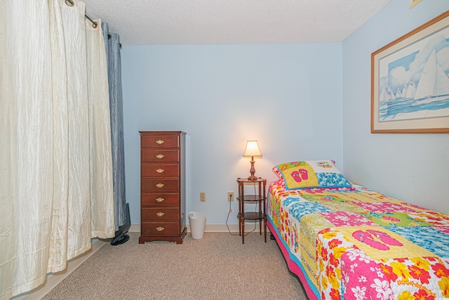 carpeted bedroom with a textured ceiling