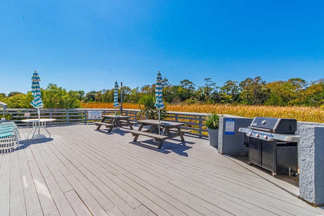 wooden terrace featuring a grill